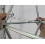 Two people expanding the aluminum frame of a curved fabric pop-up display
