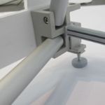 Close-up of aluminum frame connector and adjustable foot on a straight fabric pop-up display
