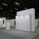 Straight fabric pop-up display installed in a professional trade show booth with overhead lighting