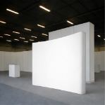 White curved fabric pop-up display installed in an indoor trade show booth